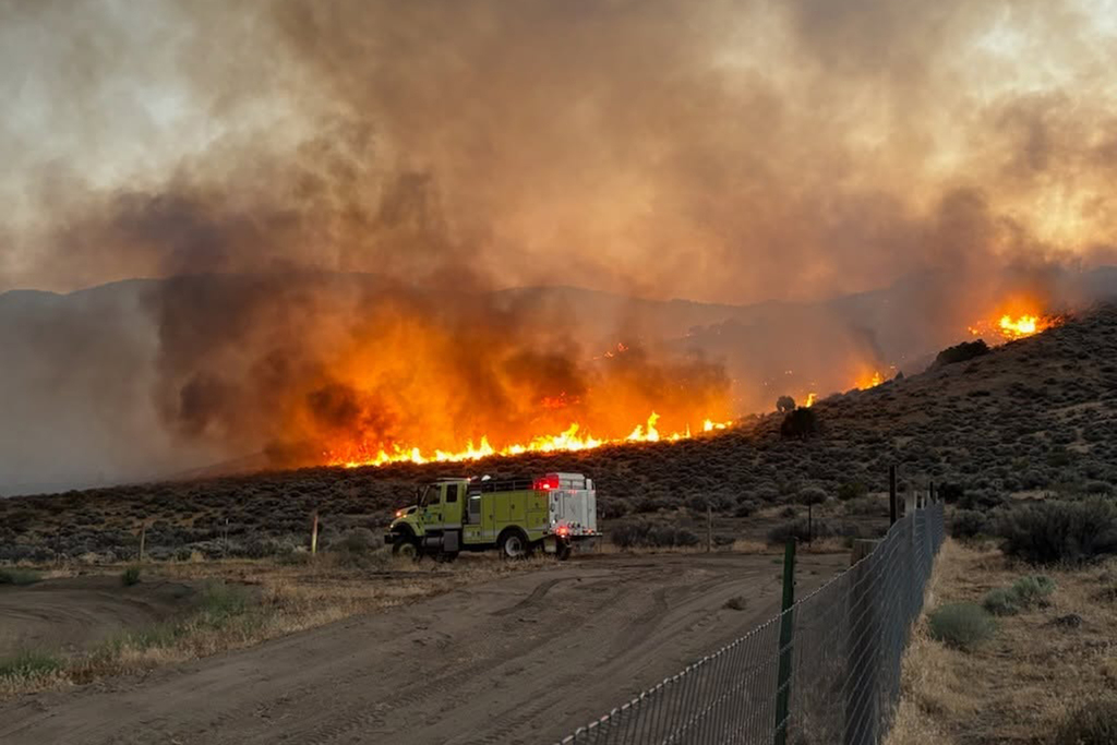 Massive wildfire erupts with fire tornado near Calif. border.