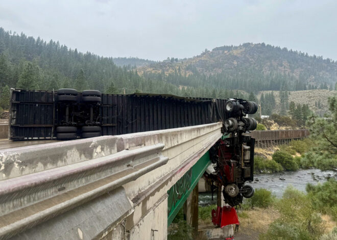 Big rig crashes through I-80 railing, cab left dangling over bridge